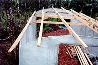 [view from above left rear of partially completed roof framing]