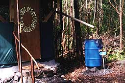[Roof catchment water feeds hand-washing water barrel and sink]